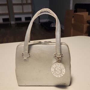 Fun, stylish designer bag-shaped piggy bank.
